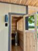 Picture of Traditional Beige Pine Outdoor Sauna, Sloped Roof, Viewing Window, Wood-Fired Heater