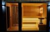 Picture of Dark Grey Solid Wood Sauna Room with Sliding Door and Tiered Seating, Modern Commercial Design