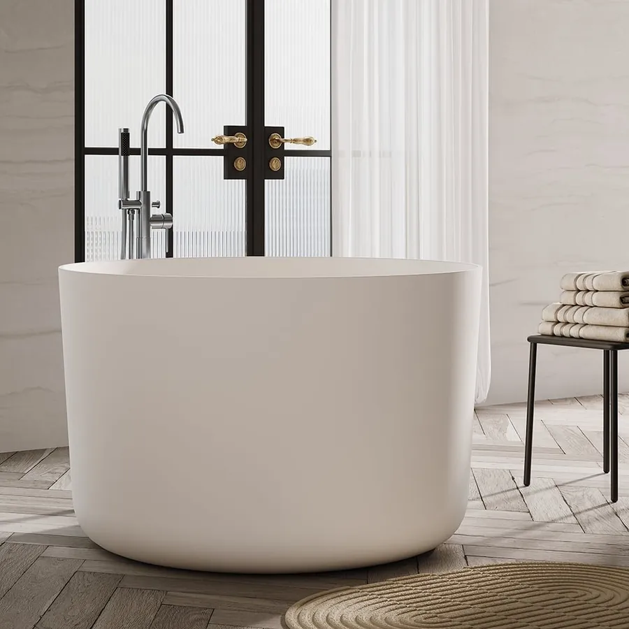 Japanese round freestanding bath by floor-to-ceiling windows